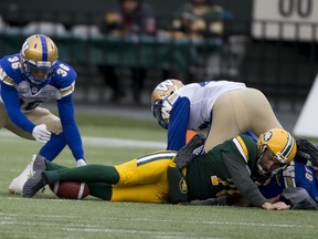 Edmonton Eskimos Hugh O'Neill (70) had his punt blocked and the ball retrieved by Winnipeg Blue Bombers Marcus Sayles during first half CFL action on Saturday, Sept. 29, 2018 in Edmonton.