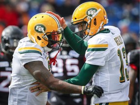 Edmonton Eskimos running back C.J. Gable, left, celebrates his touchdown with quarterback Mike Reilly during first half CFL football action in Calgary, Monday, Sept. 3, 2018.