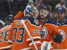 Edmonton Oilers' goalie Cam Talbot (33) and Ty Rattie (8) celebrate the win over the Vancouver Canucks' during preseason action in Edmonton on Tuesday September 25, 2018.