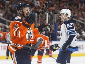 Winnipeg Jets' Mason Appleton (82) skates past as Edmonton Oilers' Ty Rattie (8) celebrates a goal during second period pre-season action in Edmonton on Thursday, Sept. 20, 2018.