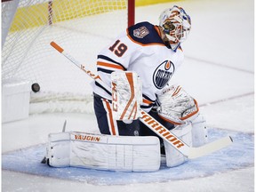 Edmonton Oilers goalie Mikko Koskinen lets in a goal from the Calgary Flames during first period preseason NHL hockey action in Calgary, Monday, Sept. 17, 2018.