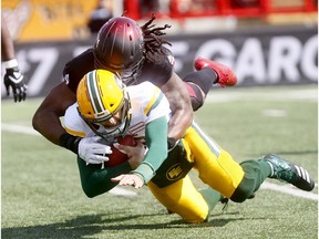 Calgary Stampeders, Junior Turner sacks Edmonton Eskimos QB, Mike Reilly in first half action during the Labour Day Classic at McMahon stadium in Calgary on Monday September 3, 2018.