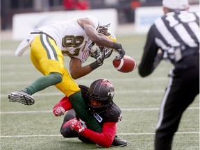 Calgary Stampeders, Tre Robinson tackles Edmonton Eskimos, Derel Walker in first half action during the Labour Day Classic at McMahon stadium in Calgary on Monday September 3, 2018.