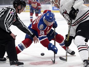 The Edmonton Oil Kings' Vince Loschiavo (18) takes a face-off against the Red Deer Rebels' Jeff de Wit (9) during first period WHL action at Rogers Place, Friday, Sept. 21, 2018.
