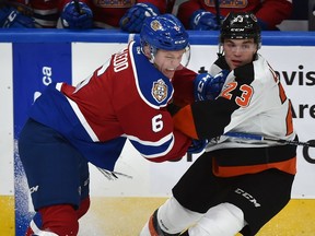 Edmonton Oil Kings Wyatt McLeoad (6) and Medicine Hat Tigers Bryan Lockner (23) battle along the blueline during WHL action at Rogers Place in Edmonton, September 26, 2018.