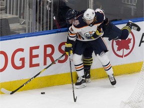 Edmonton Oilers rookie William Lagesson fights for the puck against NAIT- MacEwan All- Stars' Brayden Harris during first period action Tuesday, Sept. 11, 2018.