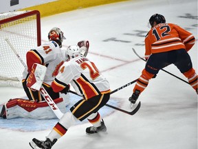 Edmonton Oilers Jakub Jerabek (12) sskates in on goal against Calgary Flames goalie Mike Smith during pre-season NHL action at Rogers Place in Edmonton, September 29, 2018.