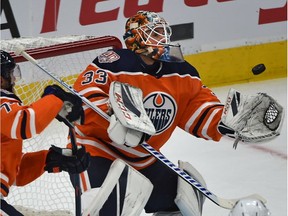 Edmonton Oilers goalie Cam Talbot (33) juggles the puck off a shot from a Vancouver Canucks players during NHL pre-season action at Rogers Place in Edmonton, September 25, 2018.