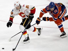 The Edmonton Oilers' Jesse Puljujarvi (98) chases the Calgary Flames' Alex Chiasson (39) during third period NHL action at Rogers Place, in Edmonton on Wednesday Oct. 12, 2016. The Oilers won 7-4. Photo by David Bloom Photos off Oilers game for multiple writers copy in Oct. 13 editions.