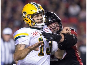 Edmonton QB Mike Reilly is forced to throw away the football by Ottawa's Zack Evans in the second quarter as the Ottawa Redblacks take on the Edmonton Eskimos in CFL action at TD Place last season.