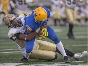 Edmonton Huskies Shaydon Philips tackles Hilltops receiver Jason Price during the Prairie Football Conference at SMF Field in Saskatoon, Sask., on Sunday, October 28, 2018.