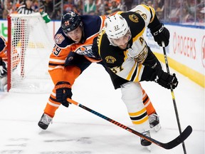 Leon Draisaitl of the Edmonton Oilers chases Patrice Bergeron of the Boston Bruins at Rogers Place, Oct. 18, 2018.