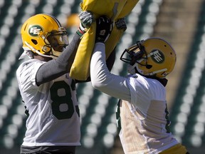 Torrance Gibson, left, and Kenny Stafford take part in an Edmonton Eskimos' team practice at Commonwealth Field, Wednesday, Oct. 3, 2018.
