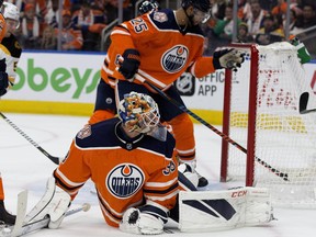 A shot by Boston Bruins' Brad Marchand gets past Edmonton Oilers' goalie Cam Talbot but is knocked out of the air by Darnell Nurse during first period NHL action at Rogers Place in Edmonton on Thursday, Oct. 18, 2018.