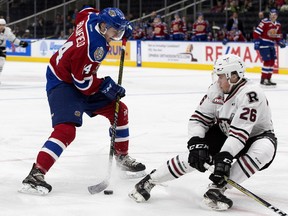 The Edmonton Oil Kings' Quinn Benjafield (14) battles the Red Deer Rebels' Chase Leslie (26) during first period WHL action at Rogers Place, in Edmonton Friday Oct. 19, 2018. Photo by David Bloom