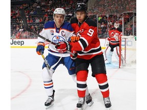 Connor McDavid, left, of the Edmonton Oilers goes head-to-head with Taylor Hall of the New Jersey Devils during the first period at the Prudential Center on January 7, 2017 in Newark, New Jersey.