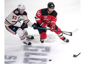 Edmonton Oilers Ryan Nugent-Hopkins and New Jersey Devils Marcus Johansson, right, battle for the puck during the season-opening NHL Global Series ice hockey match between Edmonton Oilers and New Jersey Devils at Scandinavium in Gothenburg, Sweden, on October 6, 2018.