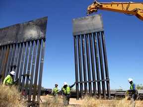 Workers replace an old section of the border fence between the U.S. and Mexico in Santa Teresa, New Mexico, on April 23, 2018.