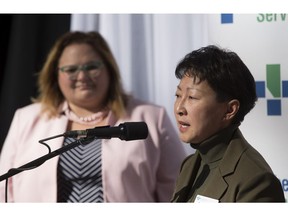 Dr. Verna Yiu, president and CEO of Alberta Health Services, speaks while Health Minister Sarah Hoffman listens on Wednesday, Oct. 3, 2018 during an announcement that the Government of Alberta is investing $12 million to advance the development of a new neurosciences intensive care unit at the University of Alberta Hospital in Edmonton.