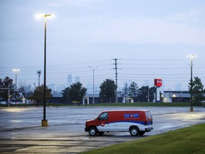 A Canada Post Corp. van sits in the Gateway Postal Facility parking lot during a Canadian Union of Postal Workers (CUPW) strike in Toronto, on Tuesday.