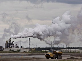 A dump truck works near the Syncrude oil sands extraction facility near the city of Fort McMurray, Alta., on June 1, 2014.