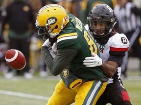 Edmonton Eskimos wide receiver D'haquille Williams (left) drops the ball as he is tackled by Ottawa Redblacks defensive back Jonathan Rose during CFL game action in Edmonton on Saturday October 13, 2018.