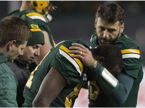 Edmonton Eskimos quarterback Mike Reilly (13) speaks to injured D'haquille Williams (81) during second half CFL action in Edmonton, Alta., on Saturday September 29, 2018.