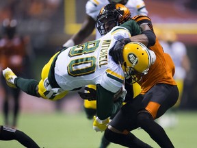 BC Lions defensive back Anthony Orange (26) stops Edmonton Eskimos wide receiver Bryant Mitchell (80) during CFL football action in Vancouver, B.C., on Friday, Oct. 19, 2018.