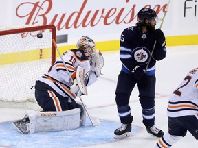 Winnipeg Jets' Blake Wheeler (26), not shown, scores with Mathieu Perreault screening Edmonton Oilers' goaltender Mikko Koskinen (19) during third period preseason NHL hockey action in Winnipeg, Sunday, September 23, 2018.