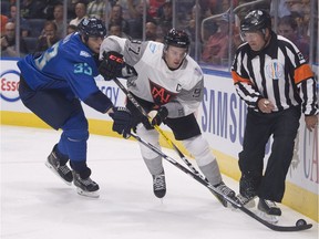 Team North America's Connor McDavid skates to puck behind the net as Team Europe's Zdeno Chara, left, chases him during first period of a pre-tournament game at the World Cup of Hockey, Thursday, September 8, 2016 in Quebec City.