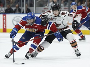Edmonton's Jake Neighbours, left, battles Calgary's Vladislav Yeryomenko during the second period of a WHL game between the Edmonton Oil Kings and the Calgary Hitmen at Rogers Place in Edmonton, Alberta on Saturday, March 17, 2018.