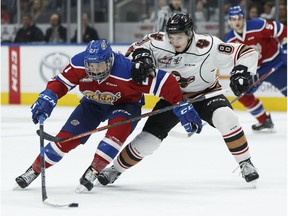 Edmonton's Jake Neighbours (left) battles Calgary's Vladislav Yeryomenko during the second period of a WHL game between the Edmonton Oil Kings and the Calgary Hitmen at Rogers Place in Edmonton, Alberta on Saturday, March 17, 2018. Ian Kucerak / Postmedia