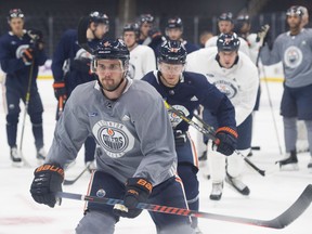 Kris Russell is followed into the corner by Alex Chiasson during Edmonton Oilers practice at Rogers Place on Wednesday, Oct. 17, 2018 ahead of their season opening game against Boston.