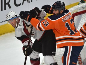 Edmonton Oilers Jason Garrison (13) pushes Arizona Coyotes Christian Fischer (36) during NHL preseason action at Rogers Place in Edmonton, September 27, 2018.