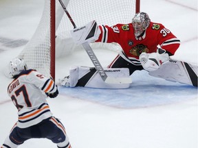 Edmonton Oilers' Connor McDavid scores the winning goal against Chicago Blackhawks' Cam Ward during overtime Sunday, Oct. 28, 2018, in Chicago.