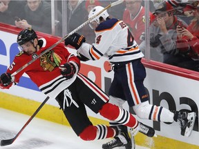 Chicago Blackhawks Artem Anisimov, left, collides with Edmonton Oilers' Kris Russell during the second period of an NHL hockey game Sunday, Oct. 28, 2018, in Chicago.