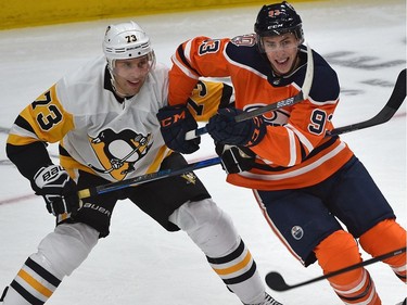 Edmonton Oilers' Ryan Nugent-Hopkins and Pittsburgh Penguins' Jack Johnson battle at Rogers Place, on Tuesday, Oct. 23, 2018.