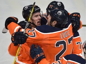Edmonton Oilers Connor McDavid (97) celebrates his tying goal with Milan Lucic (27) and Oscar Klefbom (77) Pittsburgh Penguins during NHL action at Rogers Place in Edmonton, October 23, 2018.