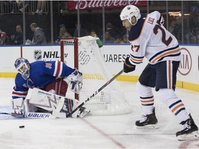 New York Rangers goaltender Henrik Lundqvist (30) makes the save against Edmonton Oilers left wing Milan Lucic (27) during the third period of an NHL hockey game, Saturday, Oct. 13, 2018, at Madison Square Garden in New York. The Oilers won 2-1.