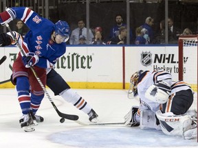 Edmonton Oilers goaltender Cam Talbot (33) makes the save against against New York Rangers left wing Jimmy Vesey (26) during the second period of an NHL hockey game, Saturday, Oct. 13, 2018, at Madison Square Garden in New York.