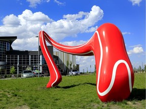 Public artwork titled, The Running Track, a large, dynamic, bold, red sculpture, sits in front of the Terwillegar Community Recreation Centre in Edmonton Alta. The sculpture stands about five metres high, is eight metres long and it weighs around 2,270 kilograms.