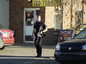 Police investigate a shooting at CarProof Auto Repair in downtown Edmonton on Tuesday October 23, 2018. (Photo by Larry Wong/Postmedia)