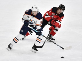 Edmonton Oilers' Ryan Nugent-Hopkins and New Jersey Devils' Nico Hischier vie for the puck, during the season-opening NHL Global Series hockey match between Edmonton Oilers and New Jersey Devils at Scandinavium in Gothenburg, Sweden, Saturday, Oct. 6, 2018,