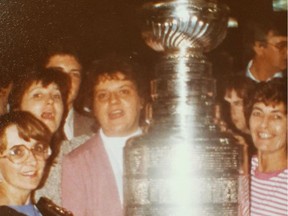 Sheila McCaskill and Oilers staff pose with the Stanley Cup in 1988. Supplied