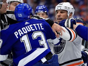 Cedric Paquette #13 of the Tampa Bay Lightning and Milan Lucic #27 of the Edmonton Oilers exchange words during a game  at Amalie Arena on November 6, 2018 in Tampa, Florida.
