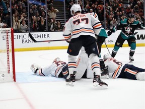 Oscar Klefbom #77, Mikko Koskinen #19 and Adam Larsson #6 of the Edmonton Oilers look on as Nick Ritchie #37 of the Anaheim Ducks reacts to scoring a goal during the third period of a game at Honda Center on November 23, 2018 in Anaheim, California.