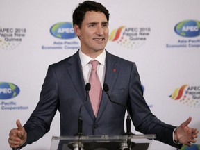 Prime Minister Justin Trudeau answers questions from reporters after attending the APEC 2018 Economic Leaders Meeting in New Guinea on Nov. 18, 2018. (AP Photo/Aaron Favila)