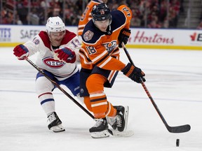The Edmonton Oilers' Ryan Strome battles the Montreal Canadiens' Max Domi during third period NHL action at Rogers Place, Tuesday, Nov. 14, 2018