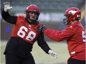 (left to right) The Calgary Stampeders Justin Lawrence (68) and Brad Erdos (53) take part in a team practice at Commonwealth Stadium, in Edmonton Friday November 23, 2018. The Stampeders will face the Ottawa Redblacks in the Grey Cup this Sunday.