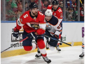 Ryan Nugent-Hopkins #93 of the Edmonton Oilers purses Aaron Ekblad #5 of the Florida Panthers at the BB&T Center on March 17, 2018 in Sunrise, Florida. The Oilers defeated the Panthers 4-2.